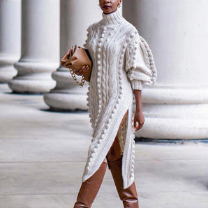
A woman wearing a luxury cable knit sweater dress with a high collar and long sleeves, showcasing a fashionable and stylish look.