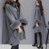 
A women's luxury camel wool cape in black with faux fur trim, featuring a wide shoulder design and long sleeves. The cape is shown in a 5XL size, highlighting its elegant overcoat style with a focus on the neckline and waist area.