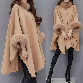 Women's winter cape made from luxury camel wool in a brown color, featuring a faux fur trim. The cape is designed to fit a plus-size 5XL, showcasing elegant outerwear that covers the shoulders and neck area. The garment is crafted to provide warmth and style, ideal for the colder months.