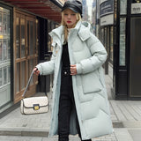 Oversized black puffer down jacket featuring a luxurious fur-lined hood, showcased in a detailed photograph. The design highlights include a sleek overcoat style, prominent sleeves, and a distinctive collar, exuding sophistication and warmth.