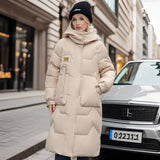 Oversized beige luxury designer down jacket with a fur hood, photographed in front of a white car.