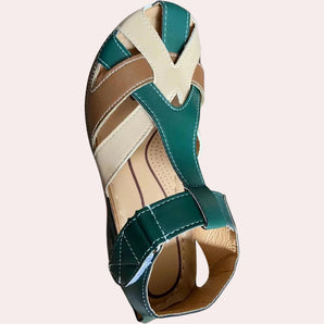 Luxury designer leather peep-toe high-heel sandals in green and tan, showcasing an elegant design with a sleek silhouette, worn on a model's feet, highlighting the stylish and sophisticated appeal of the footwear.