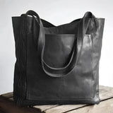 Luxury designer leather tote bag in a handmade vintage style, nero color, featuring a rectangular shape and elegant shoulder strap, perfect as a fashion accessory for business or casual use.