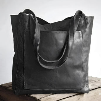 Luxury designer leather tote bag in a handmade vintage style, nero color, featuring a rectangular shape and elegant shoulder strap, perfect as a fashion accessory for business or casual use.