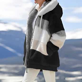 Luxury designer striped fur winter coat in Noors Zwart, featuring a 3XL size with an elegant pattern. The coat has a high neck, long sleeves, and deep pockets, reaching knee-length for optimal warmth. Suitable for cold weather, offering a sophisticated and stylish look.