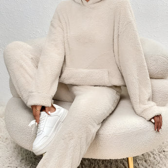 Luxury fleece loungewear set in plush beige, featuring a cozy teddy texture. The outfit includes a top with long sleeves and a collar, paired with comfortable bottoms designed to fit snugly around the waist and thigh.