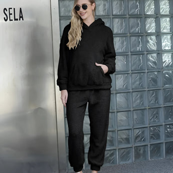 Plush beige teddy loungewear set displayed on a model, featuring a cozy fleece texture, long sleeves, and a relaxed fit, paired with casual footwear.