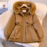 Elegant women's winter jacket in a coffee color, featuring a luxurious fur-trimmed hood. The parka, designed in size 3XL, showcases a sophisticated fashion design with a beige and fawn color palette, incorporating natural materials for warmth and style. The jacket includes a tailored collar, long sleeves, and a fashionable blazer-like appearance, offering both elegance and practicality for cold weather.