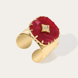 Luxury gold cuff bracelet adorned with a vibrant red gemstone, showcasing YA-CHAN's original design and craftsmanship.