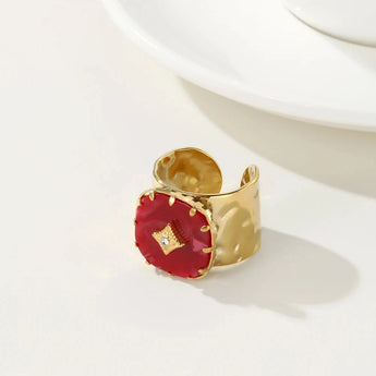 Luxury gold cuff bracelet featuring a vibrant red gemstone, showcasing YA-CHAN's original design.