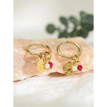 Luxury Gold Hoop Earrings with Pearl Charms displayed against a neutral background, showcasing intricate metalwork and elegant, dangling pearls.