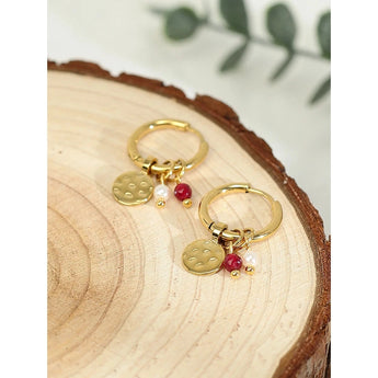 Luxury Gold Hoop Earrings with Pearl Charms displayed on a wooden surface.