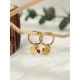 Luxury Gold Hoop Earrings with Pearl Charms by YA-CHAN Designer Jewelry, shown in close-up, displaying elegant gold hoops with delicate pearl accents.