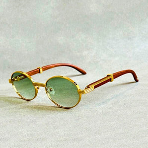 
Vintage round sunglasses with a luxurious gold frame, featuring green-tinted lenses and a designer look.