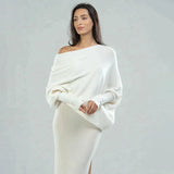 Luxury gray cashmere poncho for women, featuring an elegant designer knitwear style with a soft drape over the shoulders and a refined neckline, shown in an ivory color for a sophisticated fashion statement.