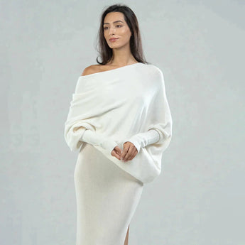 Luxury gray cashmere poncho for women, featuring an elegant designer knitwear style with a soft drape over the shoulders and a refined neckline, shown in an ivory color for a sophisticated fashion statement.