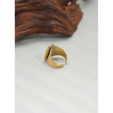 Luxury green gemstone ring with a textured 18K gold band by YA-CHAN