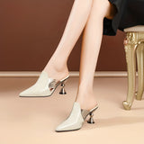 Luxury green mules with metallic heel, showcasing chic designer slip-ons in a beige white color, size 44. The image features the footwear from a side angle, highlighting its elegant design and comfortable fit.