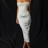 Luxury ivory embroidered bridal gown with a beaded corset, featuring a fitted sheath silhouette, delicate sleeves, and intricate detailing around the waist. The model is styled with her hair down, showcasing the elegant neckline and craftsmanship of the gown.