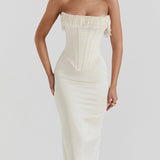 Elegant ivory bridal gown featuring intricate embroidery and a beaded corset, highlighting a one-piece design with delicate shoulder and neck details.