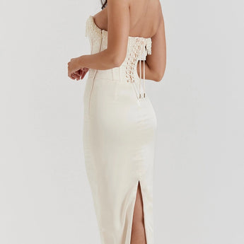 Luxury ivory embroidered bridal gown featuring a beaded corset, showcasing intricate detailing on the bodice, with elegant sleeves and a flattering neckline.