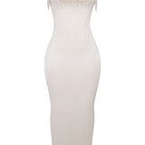 Luxury ivory embroidered bridal gown featuring a beaded corset, sheath silhouette, and elegant design details, displayed on a model showcasing the gown's intricate craftsmanship and flattering fit.