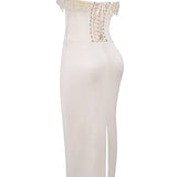 Luxury ivory embroidered bridal gown featuring a beaded corset with a sheath silhouette, sleeveless design, and intricate detailing, perfect for a modern and elegant wedding look.