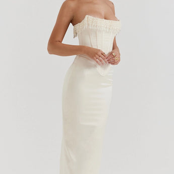 Luxury ivory strapless bridal gown featuring intricate embroidery and a beaded corset, highlighting an elegant neckline and fitted bodice for a sophisticated bridal look.