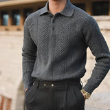 Men's outfit featuring a luxury beige knit polo sweater paired with vintage pleated trousers in gray, highlighting the sweater's collar, long sleeves, and the refined design.