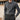 Men's outfit featuring a luxury beige knit polo sweater paired with vintage pleated trousers in gray, highlighting the sweater's collar, long sleeves, and the refined design.
