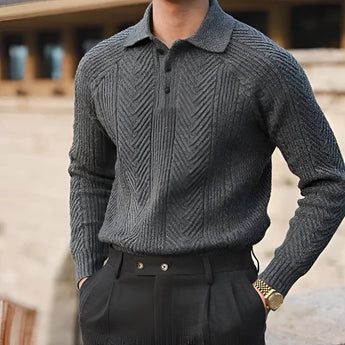 Men's outfit featuring a luxury beige knit polo sweater paired with vintage pleated trousers in gray, highlighting the sweater's collar, long sleeves, and the refined design.