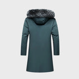 Luxury men's dark green insulated parka with faux fur hood, featuring a full-length design, grey collar, and long sleeves, styled on a mannequin.