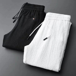 
A pair of luxury men's designer joggers made from premium cotton, showcasing a tapered fit.