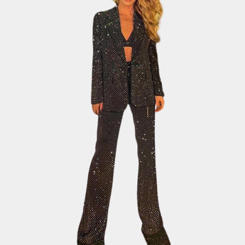 Luxury men's tailored polka dot suit in black, featuring a sleek blazer with defined collar and matching trousers, designed for formal wear in size XL.