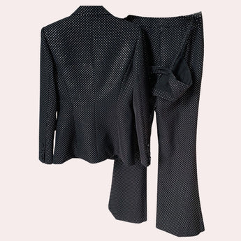 Luxury men's designer polka dot suit featuring a tailored grey blazer with long sleeves and matching trousers, showcasing a stylish pattern.