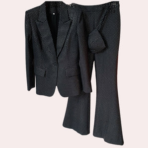 Luxury men's designer polka dot suit featuring a tailored blazer and trousers in a sleek grey color. The suit includes a dress shirt with a smart collar and neatly fitted sleeves, showcasing a modern and sophisticated style.
