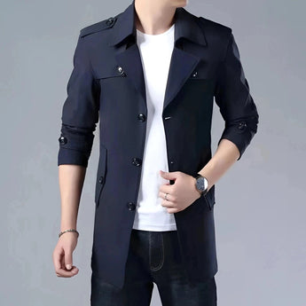 Luxury men's navy satin dress shirt with a button-down collar, tailored fit, and long sleeves, worn by a model in a formal setting. The shirt is complemented by a sleek black blazer and accessorized with a watch on the wrist. The overall look is sophisticated and elegant.