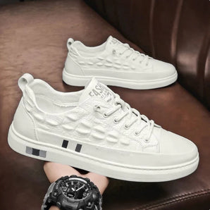 Luxury men's white leather sneakers with a crocodile texture, featuring a sleek design ideal for casual or sporty occasions.