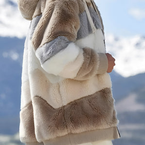 Luxurious women's winter coat made from multi-tone faux fur, featuring a stylish design with beige hues and long sleeves.