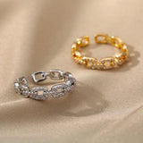 A luxurious gold link bracelet adorned with pave diamonds, worn on a woman's wrist.