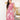 Luxury pink floral maxi dress featuring an elegant and flowing design, with long sleeves and a defined waistline, worn by a model with black hair. The dress showcases a designer evening gown style in a rich magenta hue, perfect for a sophisticated night out.