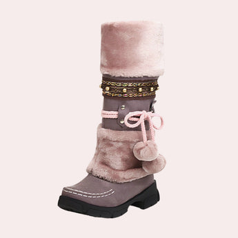 Luxury suede fur-lined winter boots in rose, featuring a boho chic design with pom-pom tie detailing, displayed in size 42.