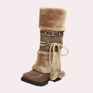 Luxury brown suede winter boots with fur lining and boho chic pom-pom tie design, displayed in size 42.