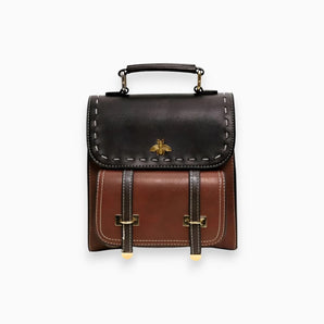 Luxury two-tone leather satchel in brown featuring a studded flap, rectangular shape, and adjustable strap.