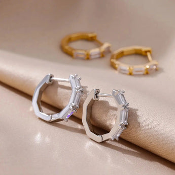 Luxury white gemstone gold hoop earrings for women with natural materials, worn on finger, body jewelry, fashion accessory.