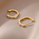 Luxury white gemstone gold hoop earrings for women featuring elegant design and sparkling gems.