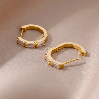 Luxury white gemstone gold hoop earrings for women featuring elegant design and sparkling gems.