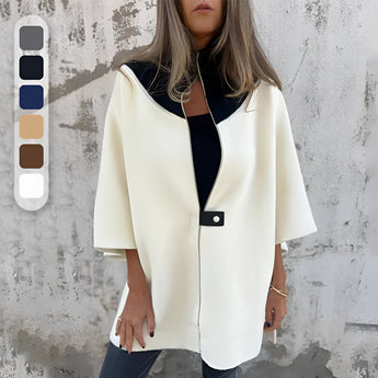 Elegant white wool cape for women, featuring a high neck collar and long sleeves, designed for winter fashion.