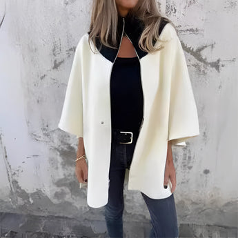 Luxury white wool cape for women in 3XL size, showcasing elegant winter fashion. The cape features a sophisticated collar and a stylish design with attention to details such as the neck and sleeves.