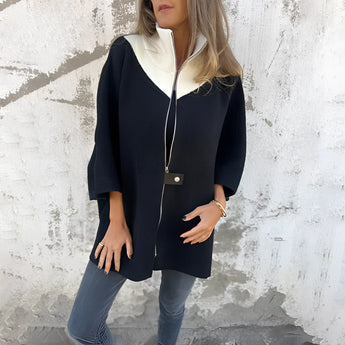 Elegant black wool cape for women, size 3XL, featuring a stylish shoulder design and a sophisticated collar.